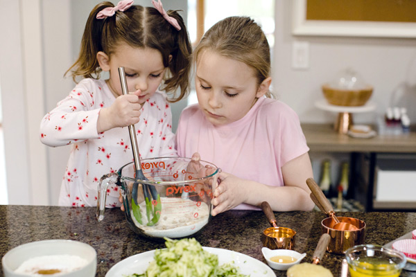 Two young girls mixing ingredients