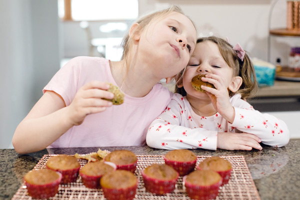 Preschoolers enjoying zucchini muffins