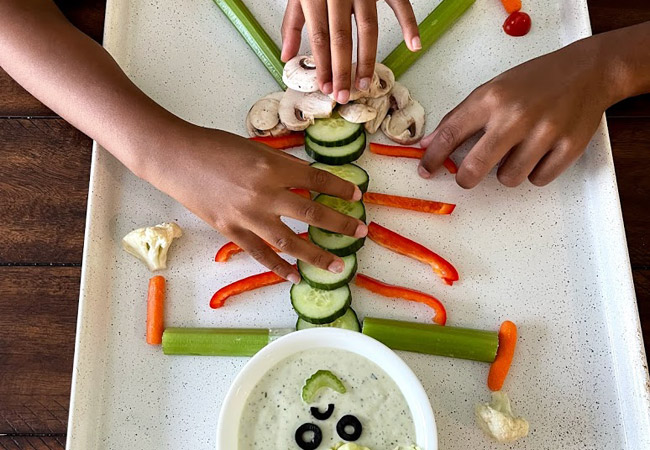 Children assembling veggie skeleton