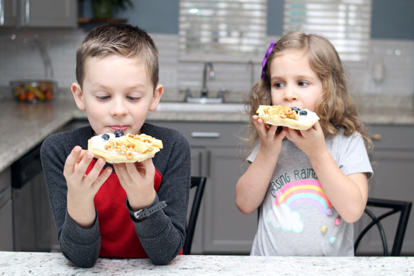 Child and preschooler enjoying ABC snack