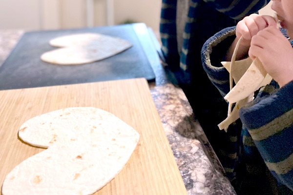 Preschoolers setting out heart-shaped tortillas