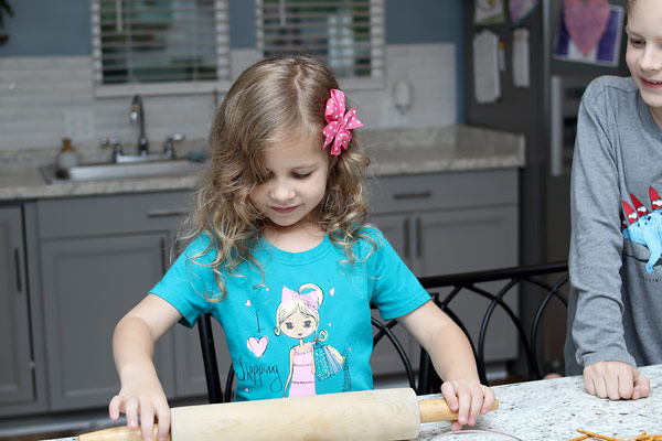 Preschooler flattening bread
