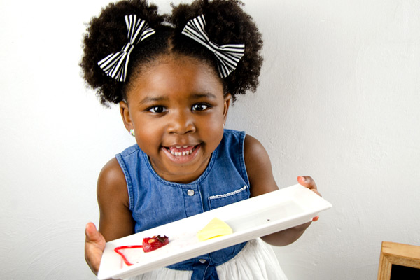 Young girl showing off finished ABC snack