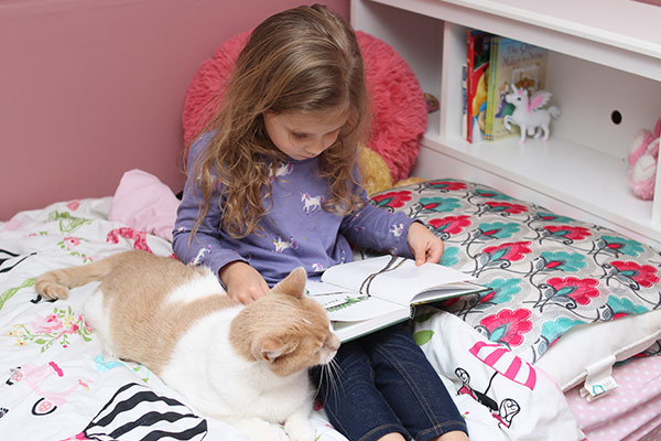 girl reading with cat