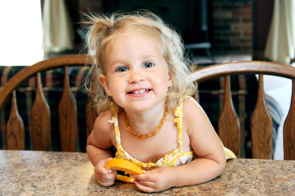 Happy young girl with orange slice
