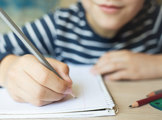 boy writing in a notebook