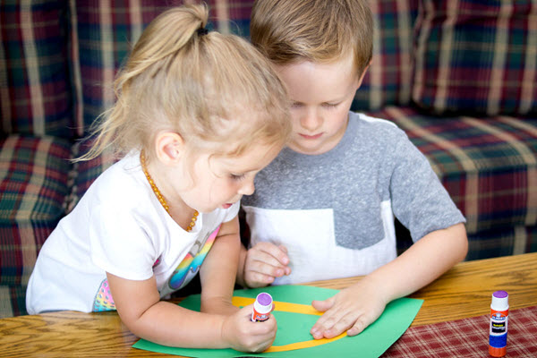 children working together on letter d craft