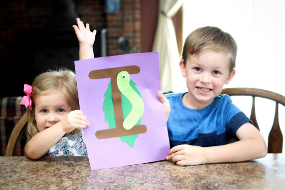 two children smiling at their finished letter I craft