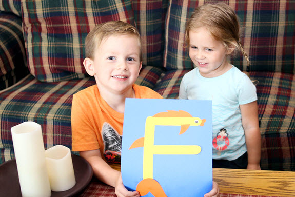 boy and girl smiling with their finished letter f craft