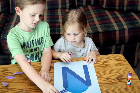 two children assembling their letter n craft