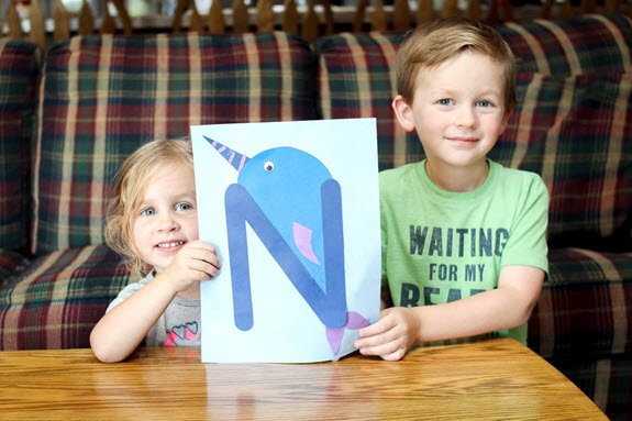 boy and girl holding their finished letter n craft