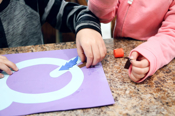 children assembling their letter q craft