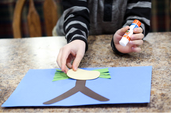 boy assembles a letter y craft