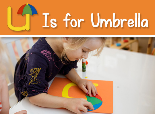 child applies a umbrella to her lowercase u craft