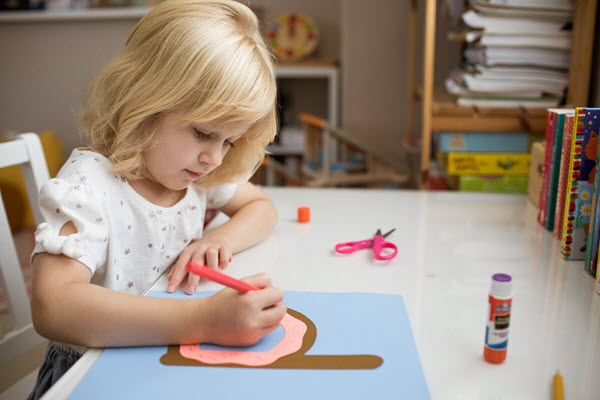 Girl drawing sprinkles on her lowercase d craft