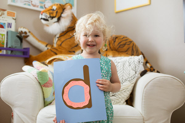 little girl displaying her lowercase d craft