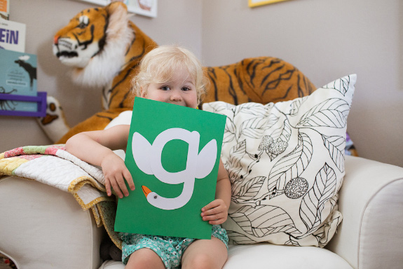 Small child displays her lowercase g craft