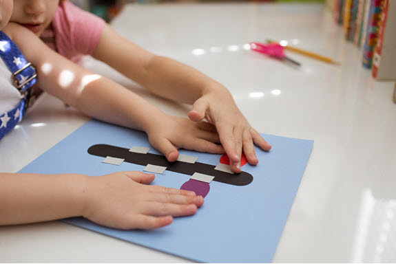 children glue their lowercase L craft
