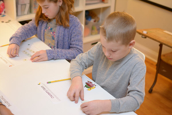 children work on creating words in Thanksgiving Scramble