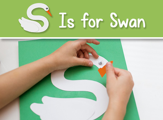 child applies a beak to her lowercase s craft