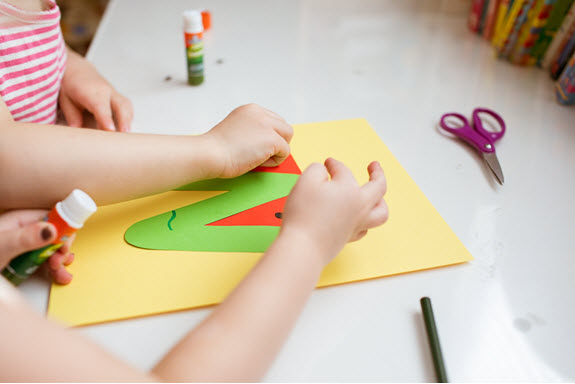 children add piece to their lowercase v craft