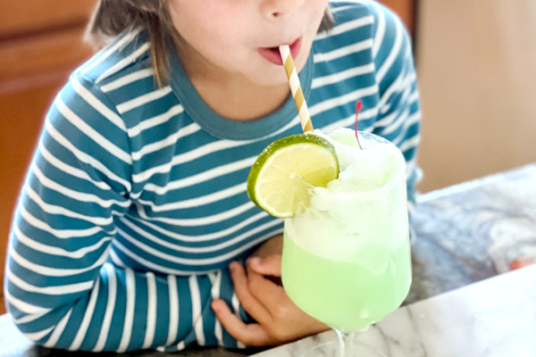 Preschooler slurping a sherbet shake