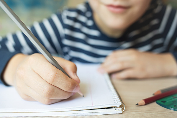 boy writing spelling dictation