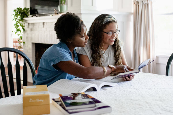 african american mother and daughter working on schoolwork together