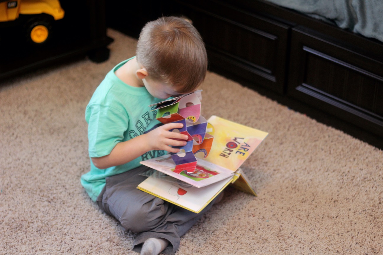 A child reading the Beautiful Oops! interactive picture book