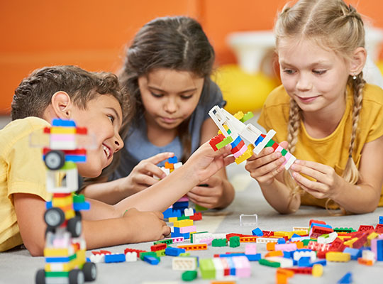 Children playing with building block toys